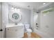 Bathroom with tiled floors, white vanity, white subway tiled shower, and a decorative mirror at 2548 Kickerillo Se Way, Atlanta, GA 30316