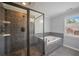 Bathroom featuring tiled floors, glass enclosed shower, and a soaking tub at 2548 Kickerillo Se Way, Atlanta, GA 30316