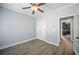 Comfortable bedroom with a ceiling fan, and sleek grey flooring, adjacent to the kitchen at 2548 Kickerillo Se Way, Atlanta, GA 30316