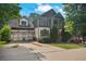 Charming two-story home with a two-car garage and a welcoming front porch in a lush, green neighborhood setting at 2548 Kickerillo Se Way, Atlanta, GA 30316