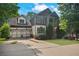 Charming two-story home with a two-car garage and a welcoming front porch in a lush, green neighborhood setting at 2548 Kickerillo Se Way, Atlanta, GA 30316