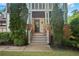 Home's inviting front entrance with stone details, columns, and manicured landscaping at 2548 Kickerillo Se Way, Atlanta, GA 30316