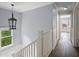 Second floor hallway with a modern chandelier and luxury grey flooring at 2548 Kickerillo Se Way, Atlanta, GA 30316