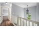 Upstairs hallway with hardwood floors and natural light at 2548 Kickerillo Se Way, Atlanta, GA 30316