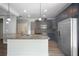 Modern kitchen features a granite island with stainless steel appliances and dark wood cabinets at 2548 Kickerillo Se Way, Atlanta, GA 30316