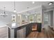 Open kitchen with granite island, stainless appliances, and seamless flow to the living area at 2548 Kickerillo Se Way, Atlanta, GA 30316