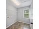 Bright laundry room featuring tile floors, a storage shelf, and a window at 2548 Kickerillo Se Way, Atlanta, GA 30316