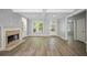Bright living room with wood floors, a brick fireplace, and large windows providing plenty of natural light at 2548 Kickerillo Se Way, Atlanta, GA 30316