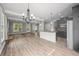 Open-concept living room featuring wood floors, a modern kitchen, and a cozy fireplace creating a welcoming space at 2548 Kickerillo Se Way, Atlanta, GA 30316
