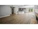 Open-concept living room featuring wood floors, a modern kitchen island, and a cozy fireplace creating a welcoming space at 2548 Kickerillo Se Way, Atlanta, GA 30316