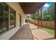 Covered patio with brick pavers, wooden support beams, and stairs to backyard at 2548 Kickerillo Se Way, Atlanta, GA 30316