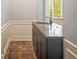 Granite-topped wet bar area with dark wood cabinets, tile floor and classic plumbing fixtures at 2548 Kickerillo Se Way, Atlanta, GA 30316