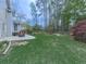 Wide backyard with green lawn, patio, fire pit and wooden deck great for outdoor enjoyment and gatherings at 3623 Spring Meadow Ct, Acworth, GA 30101