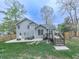 Exterior view of a home with a large backyard, deck, patio, and fire pit at 3623 Spring Meadow Ct, Acworth, GA 30101