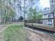 Backyard showcasing a deck, lush lawn, and mature trees at 3623 Spring Meadow Ct, Acworth, GA 30101
