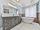 Bright bathroom with double vanity, modern fixtures, soaking tub, and natural light from a window at 3623 Spring Meadow Ct, Acworth, GA 30101