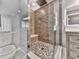 Modern bathroom features a glass shower with a built-in bench, updated vanity, and stylish tile work at 3623 Spring Meadow Ct, Acworth, GA 30101