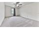 Spacious bedroom with plush carpeting, ceiling fan, and a window offering natural light at 3623 Spring Meadow Ct, Acworth, GA 30101