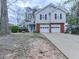 Inviting two-story home with a well-manicured front yard, brick accents, and a charming blue front door at 3623 Spring Meadow Ct, Acworth, GA 30101