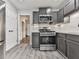 Modern kitchen featuring gray cabinets, stainless steel appliances, and light countertops at 3623 Spring Meadow Ct, Acworth, GA 30101