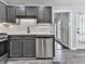 Well-lit kitchen with stainless steel appliances and gray cabinets, providing modern functionality at 3623 Spring Meadow Ct, Acworth, GA 30101