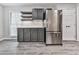 Bright kitchen with stainless steel refrigerator, gray cabinets, floating shelves, and a subway tile backsplash at 3623 Spring Meadow Ct, Acworth, GA 30101