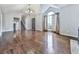 Expansive living room with hardwood floors, large window, and modern lighting at 3623 Spring Meadow Ct, Acworth, GA 30101