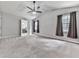 Spacious main bedroom with ensuite bathroom, ceiling fan, neutral walls, and plush carpeting at 3623 Spring Meadow Ct, Acworth, GA 30101