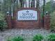 Spring Meadow Community entrance sign, indicating a swim/tennis community with lush greenery surroundings at 3623 Spring Meadow Ct, Acworth, GA 30101