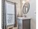 Stylish powder room features modern vanity, framed mirror, and decorative sconce at 5090 Eubanks Rd, Woodstock, GA 30188