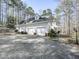 Side view of a house with an attached two car garage and a long driveway at 5090 Eubanks Rd, Woodstock, GA 30188