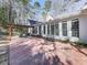 Outdoor patio with brick flooring, pergola, and view of surrounding woods at 5090 Eubanks Rd, Woodstock, GA 30188