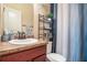 Bathroom with a white sink, brown cabinets, and decorative blue curtains at 108 Telfair Ln, Mcdonough, GA 30253