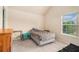 Bright bedroom with neutral walls and a large window with a view of trees at 108 Telfair Ln, Mcdonough, GA 30253