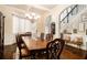 Formal dining room featuring hardwood floors, decorative lighting, and staircase at 108 Telfair Ln, Mcdonough, GA 30253