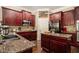 Well-equipped kitchen with granite countertops, stainless steel appliances, and dark wood cabinets at 108 Telfair Ln, Mcdonough, GA 30253