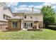 A well-manicured backyard featuring a brick patio, outdoor fireplace, and lush green lawn at 2652 Brickell Sq, Atlanta, GA 30341
