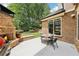 Backyard featuring a brick outdoor fireplace, grill, table, chairs, and brick exterior wall of the house at 2652 Brickell Sq, Atlanta, GA 30341