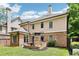 A well-manicured backyard with a brick patio and a built-in outdoor fireplace at 2652 Brickell Sq, Atlanta, GA 30341