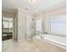 Modern bathroom with a glass shower and separate soaking tub next to a window and closet at 2652 Brickell Sq, Atlanta, GA 30341