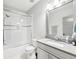 Clean bathroom featuring a shower-tub combo with sliding glass door, white cabinets and grey countertop at 2652 Brickell Sq, Atlanta, GA 30341