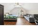 Bedroom with vaulted ceiling featuring a comfortable sofa and a well-lit desk area at 2652 Brickell Sq, Atlanta, GA 30341
