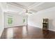 Bedroom features hardwood floors, an arcade game, natural light, and a tray ceiling with ceiling fan at 2652 Brickell Sq, Atlanta, GA 30341
