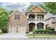Charming two-story brick home with a stone accent, inviting front porch, manicured landscaping, and a two-car garage at 2652 Brickell Sq, Atlanta, GA 30341