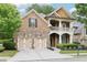 Charming two-story brick home with a stone accent, inviting front porch, manicured landscaping, and a two-car garage at 2652 Brickell Sq, Atlanta, GA 30341