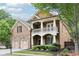 Attractive two-story brick home featuring a welcoming front porch, well-maintained landscaping, and a convenient two-car garage at 2652 Brickell Sq, Atlanta, GA 30341