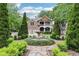 Beautiful two-story home with stone and brick, featuring a manicured front yard with a charming water fountain at 2652 Brickell Sq, Atlanta, GA 30341