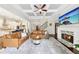Open living room with fireplace, coffered ceiling, hardwood floors, and view of modern kitchen at 2652 Brickell Sq, Atlanta, GA 30341