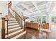 Inviting living room with a coffered ceiling, staircase, hardwood floors, and an abundance of natural light at 2652 Brickell Sq, Atlanta, GA 30341