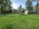 Spacious backyard featuring a storage shed, complemented by a well-maintained lawn at 661 Oak Dr, Riverdale, GA 30274